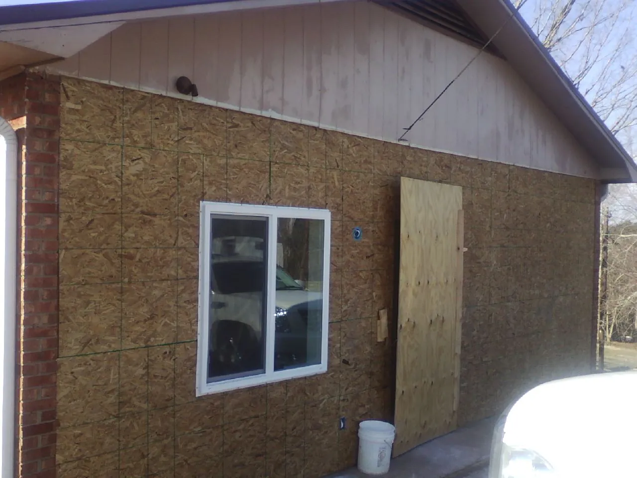 OSB sheathing on a garage addition wall before siding in Little Elm