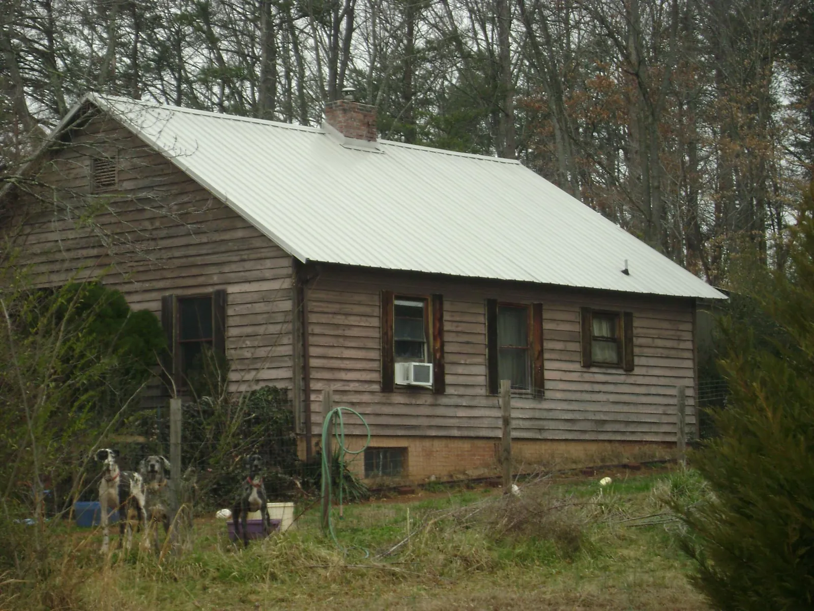 White metal roof on an old wood sided farmhouse, from a Metal Roof Installation job in Little Elm